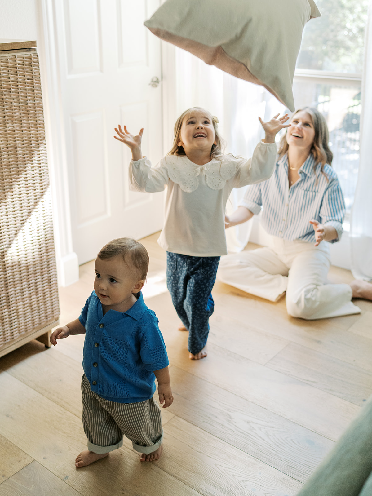 mom plays with her two kids during at-home lifestyle family session