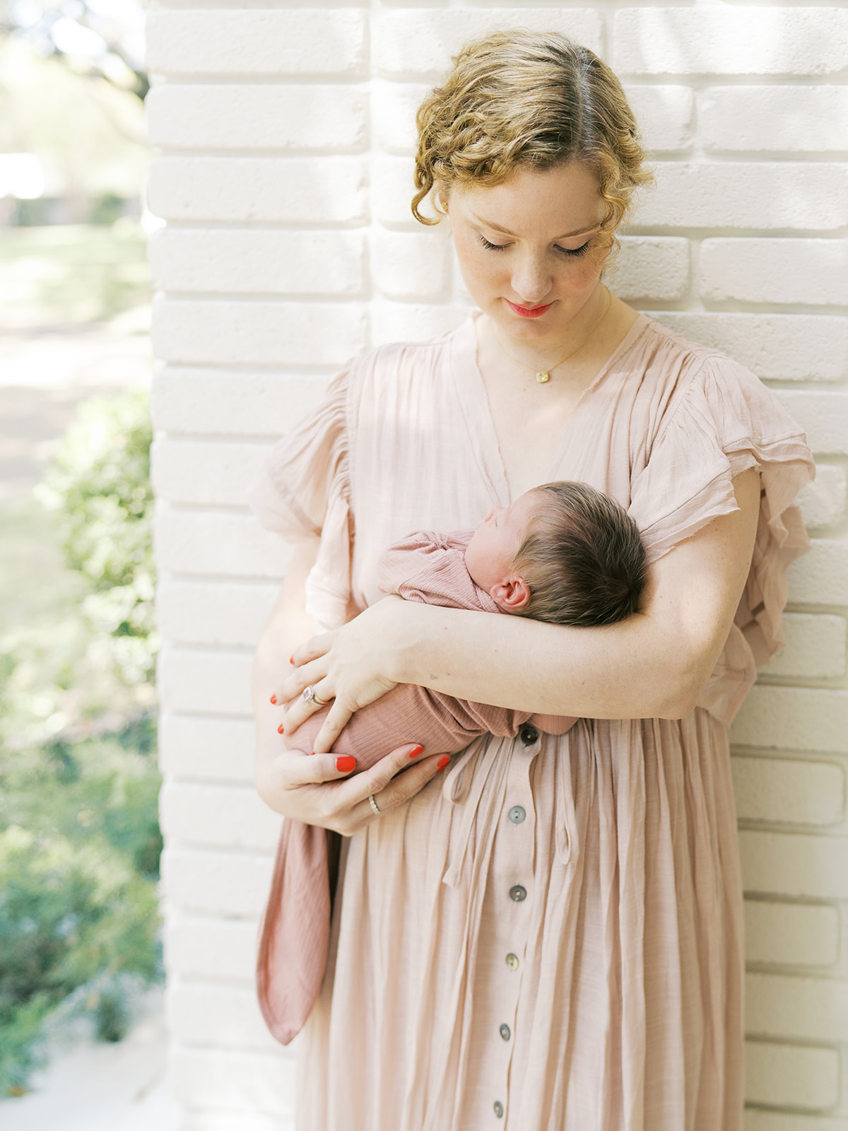 mom cradles newborn