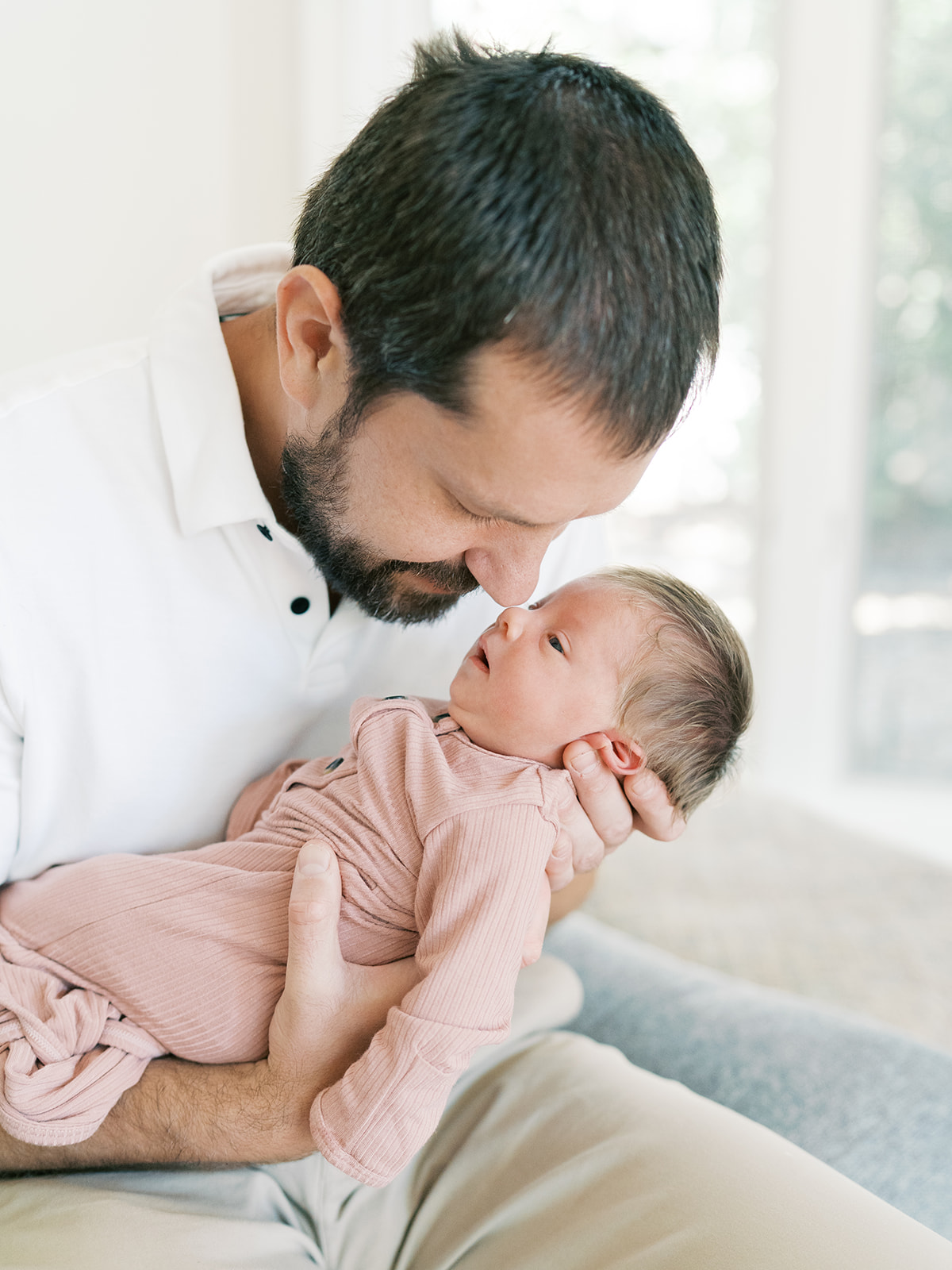 dad cuddles newborn