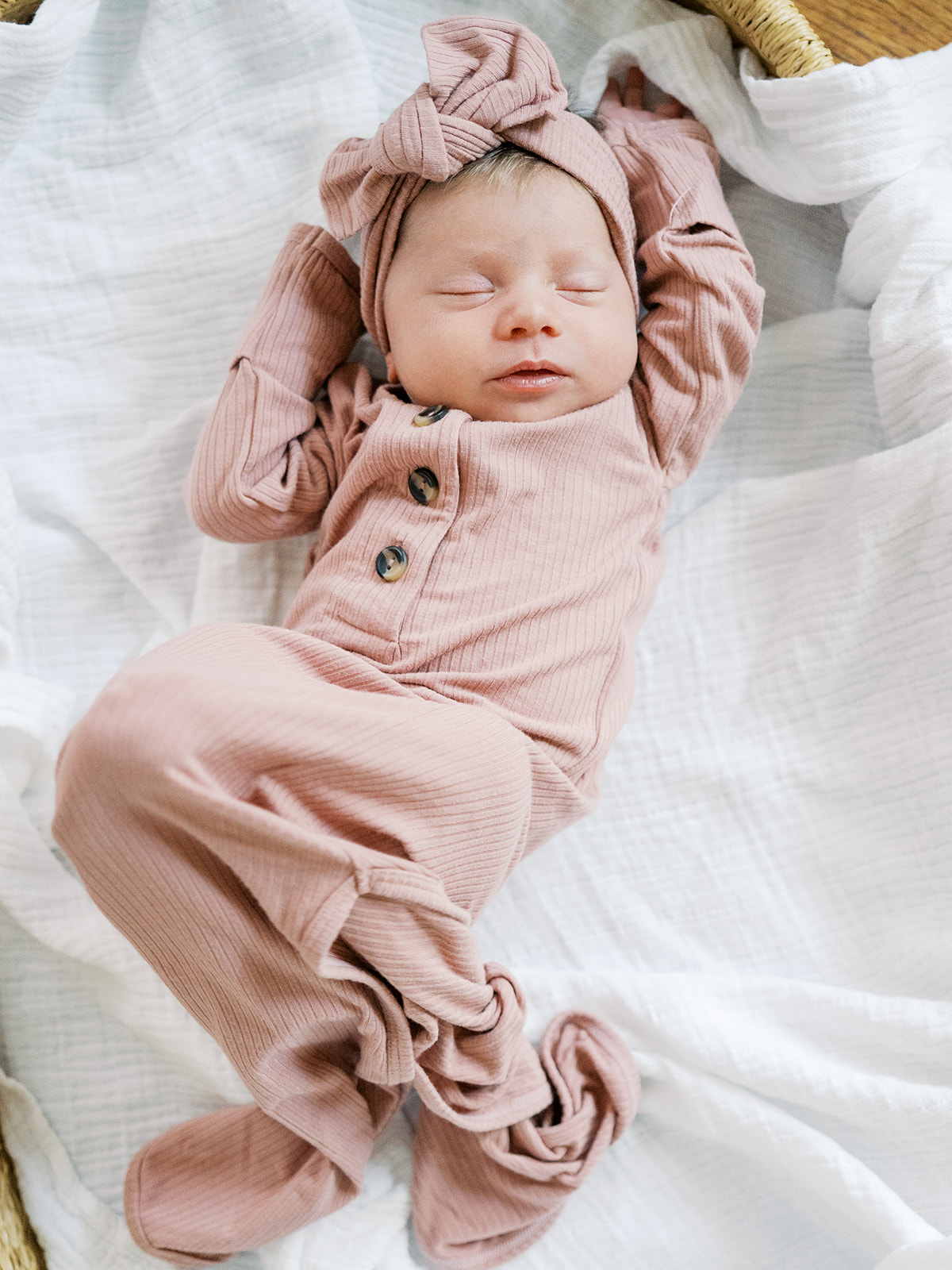 newborn in mauve outfit