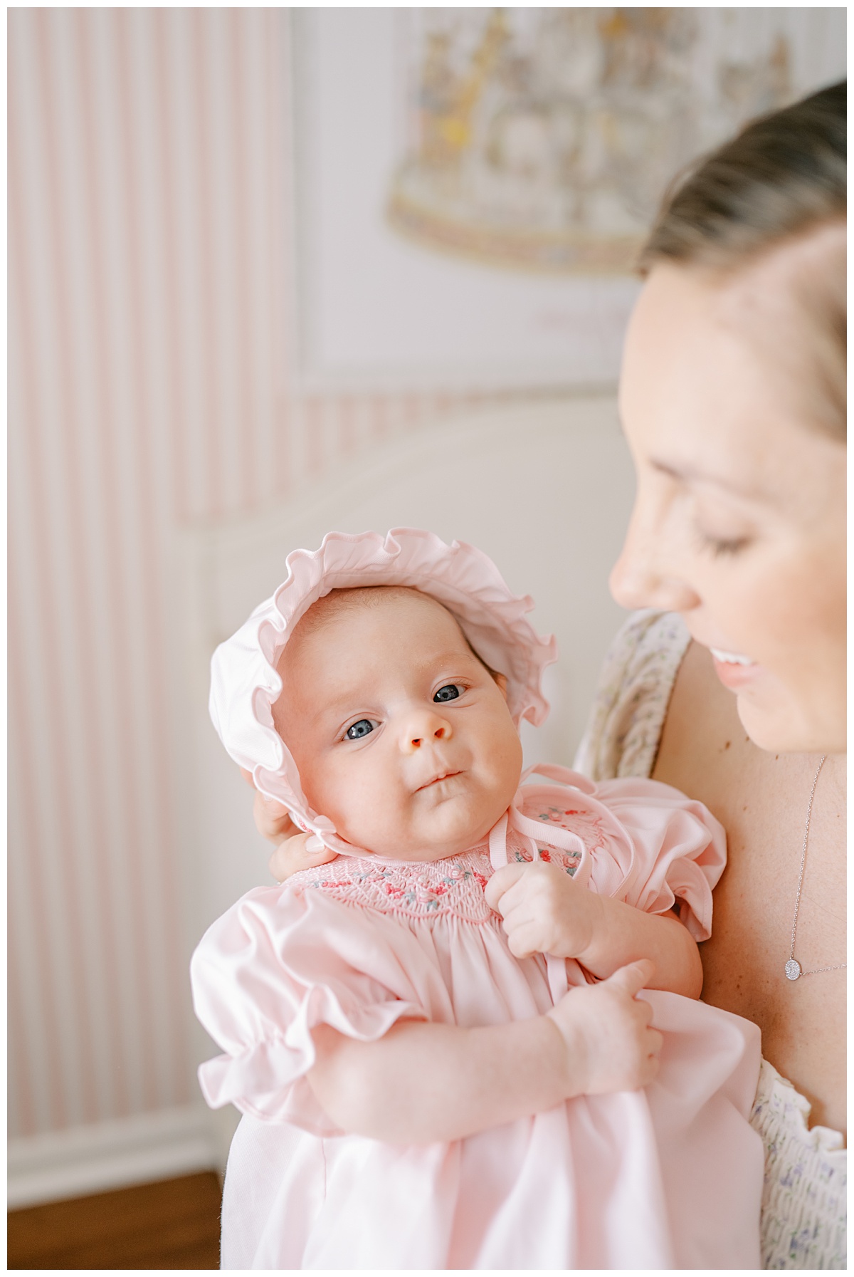 Baby girl in pink bonnet and dress for her in-home newborn pictures in San Antonio, TX taken by Teressa Jane Photography, a San Antonio Newborn Photographer.
